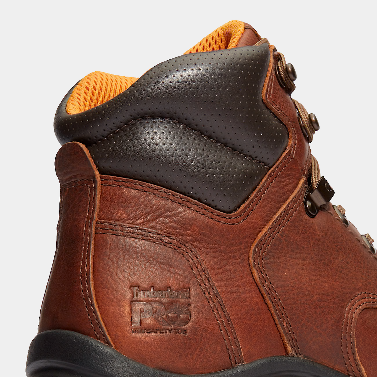 Brown safety work boots with black padded collar and orange mesh lining